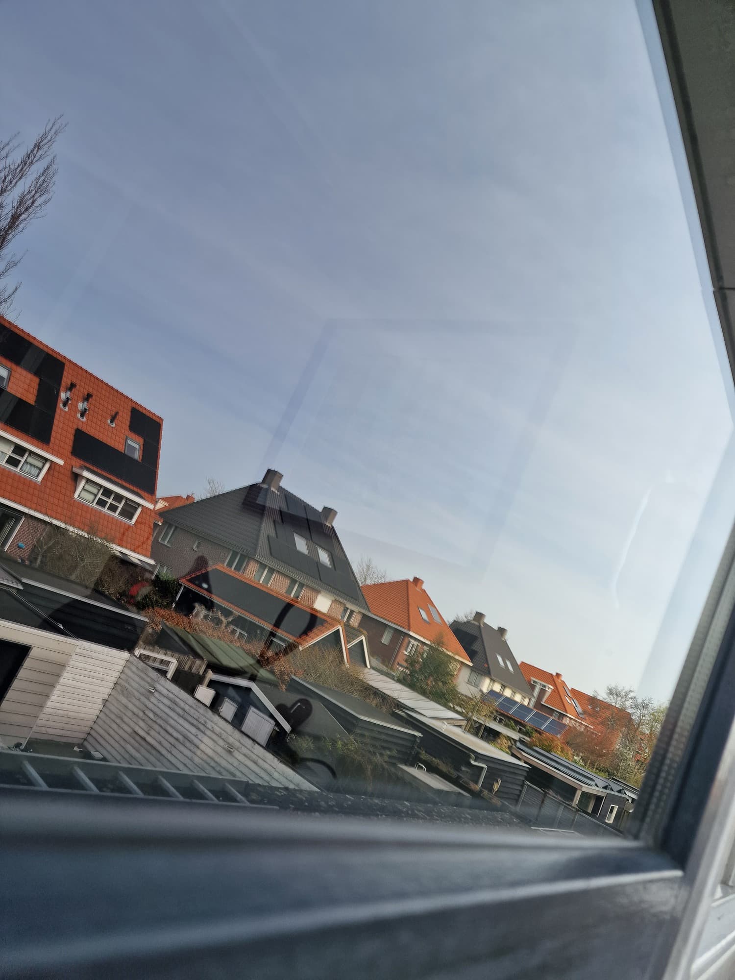 Streeploos gewassen ruit met uitzicht over Zeeuwse daken na glazenwassen door Mooi Huis Zeeland